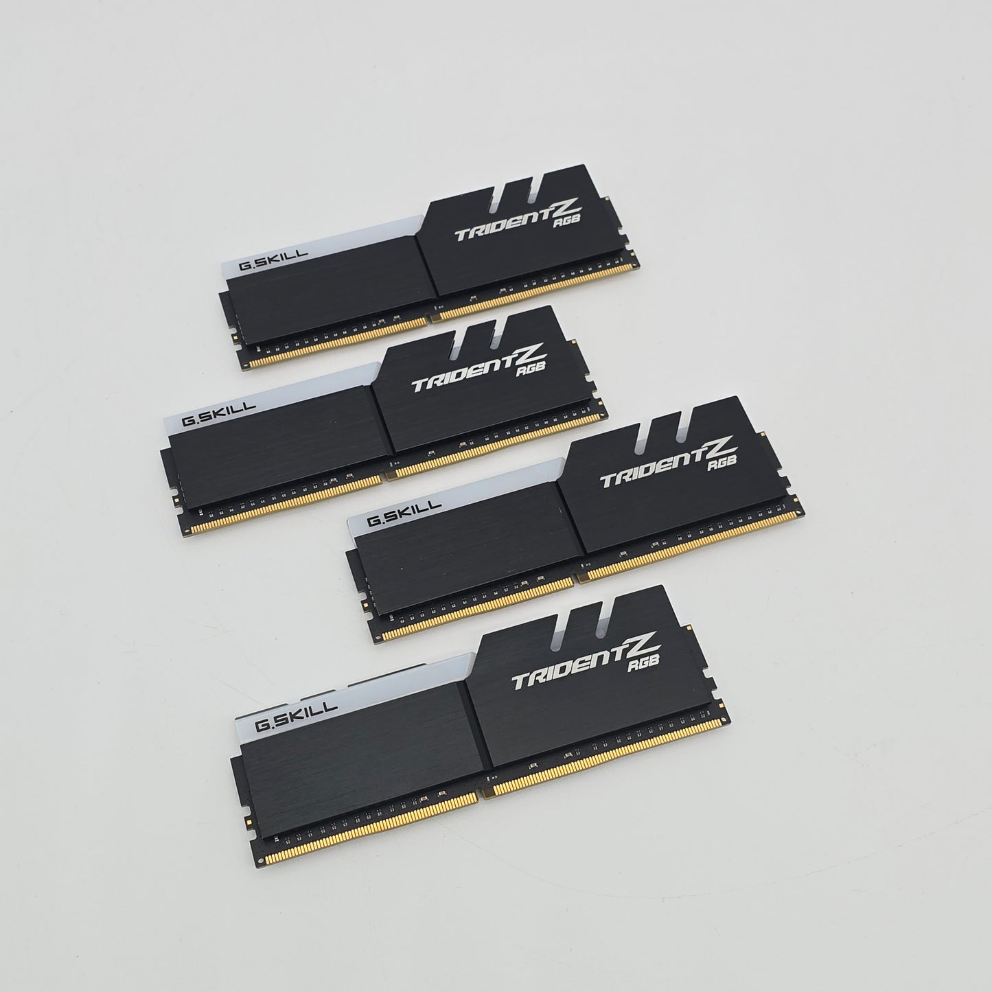 Four G.SKILL Trident Z RAM modules on a light gray background