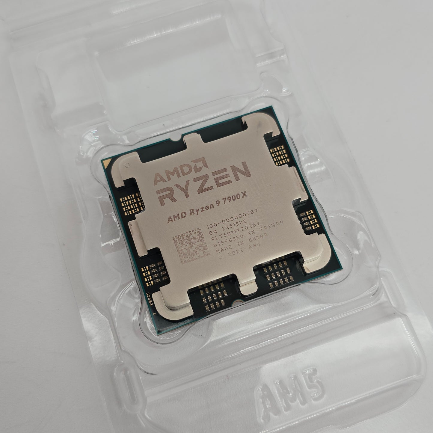 AMD Ryzen CPU in clear packaging on a light gray background