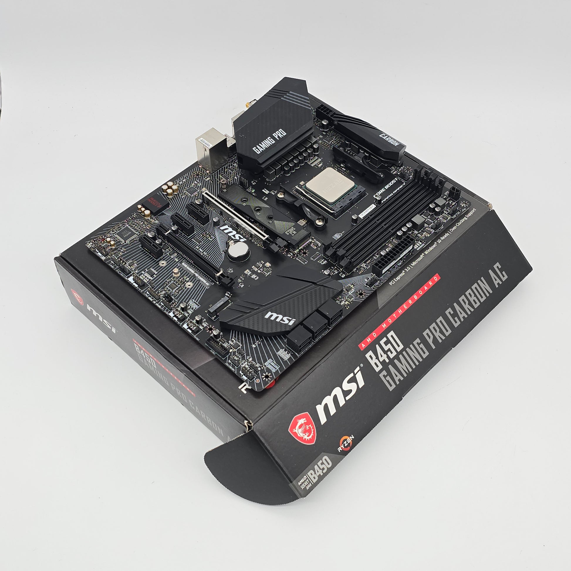 MSI computer motherboard with packaging on a light gray background