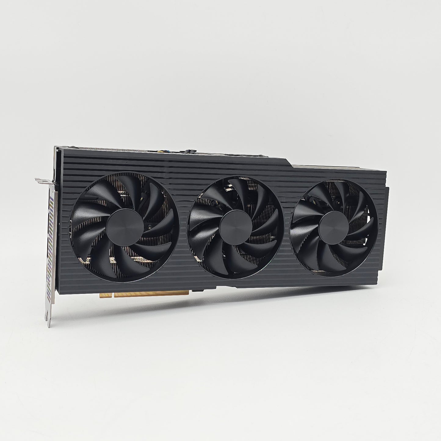 Gaming graphics card with three fans on a light gray background