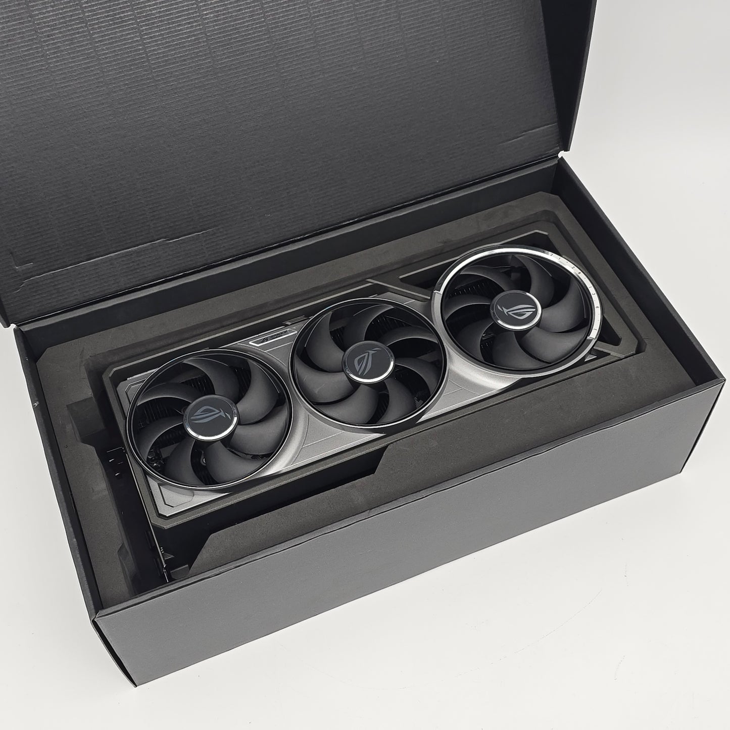 Three cooling fans in a black box on a white background