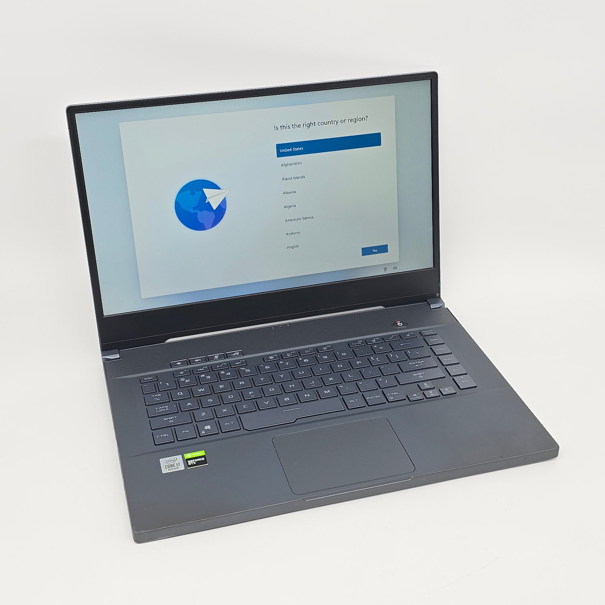 Laptop on a white background with a software installation screen.