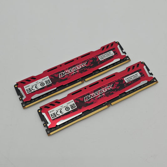Two red and black RAM sticks on a gray background
