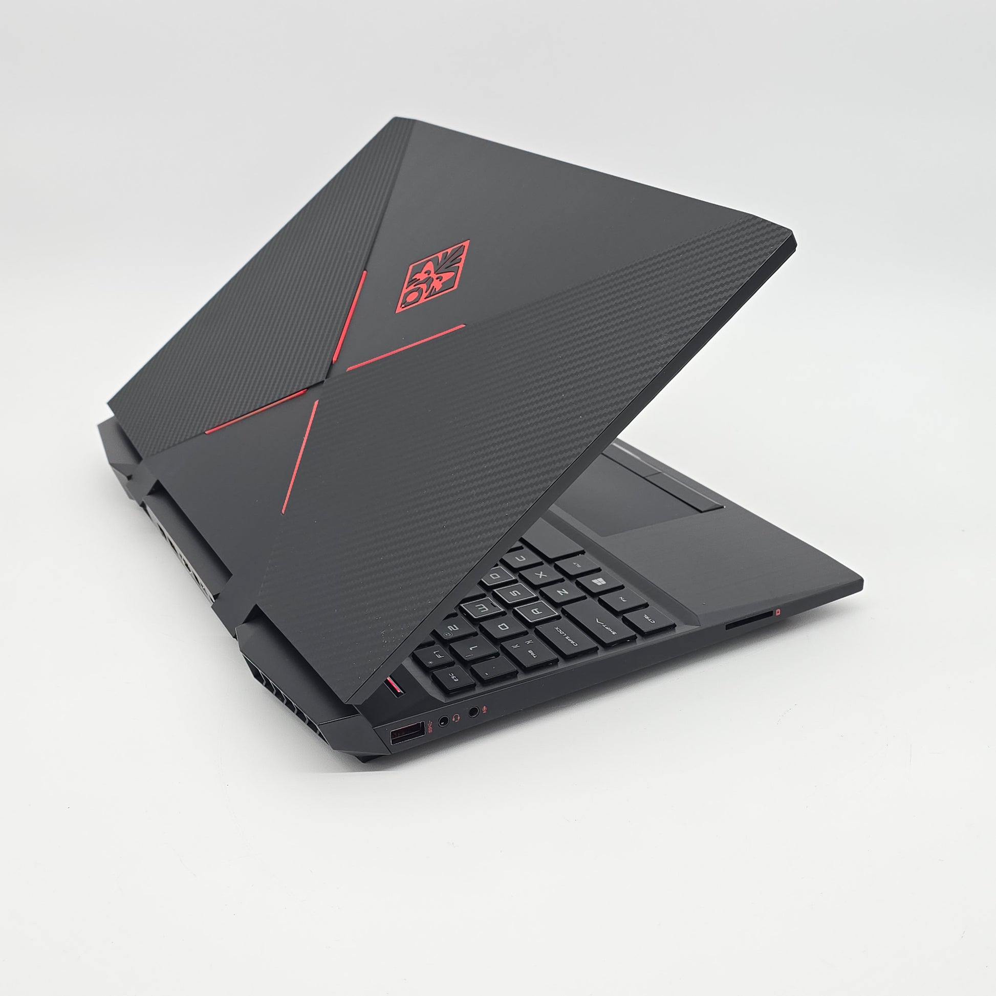 Black gaming laptop with red logo on a white background