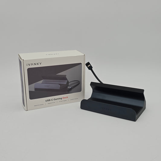Black USB-C gaming dock with packaging on a gray background