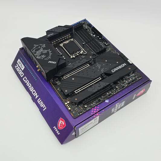 Computer motherboard on top of MSI Z690 Carbon WiFi box