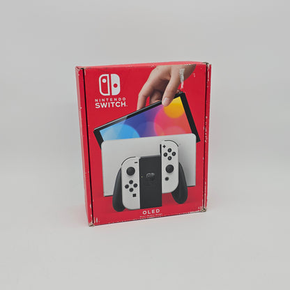 Red Nintendo Switch OLED packaging with a hand holding the console on a gray background