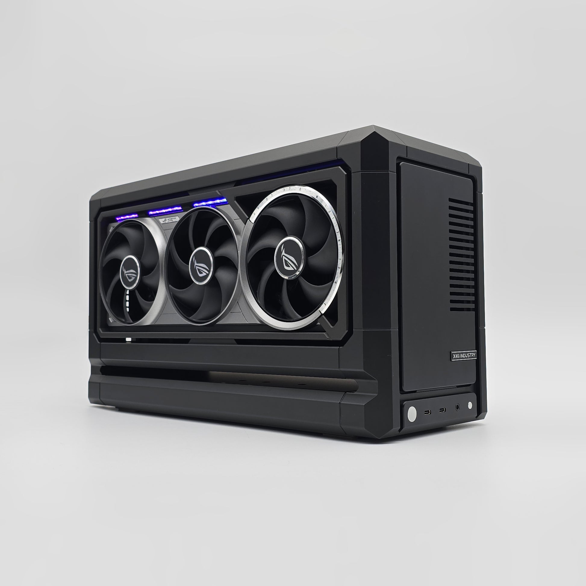 Black computer case with three fans on a light gray background