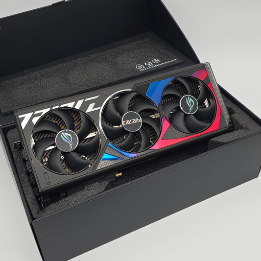 Gaming graphics card with three fans in a black box on a light gray background
