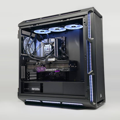 Open computer case with visible hardware components on a white background, showing a 4090 graphics card, corsair dominator titanium ram and a high end motherboard
