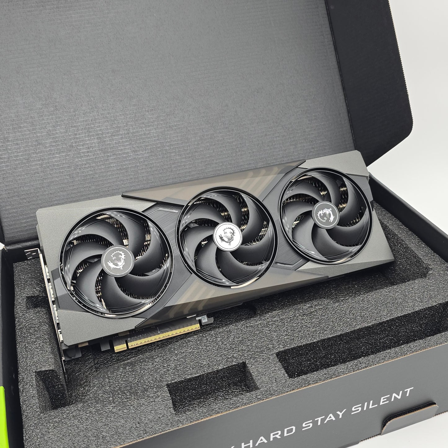 Gaming graphics card with three fans in a protective foam tray.