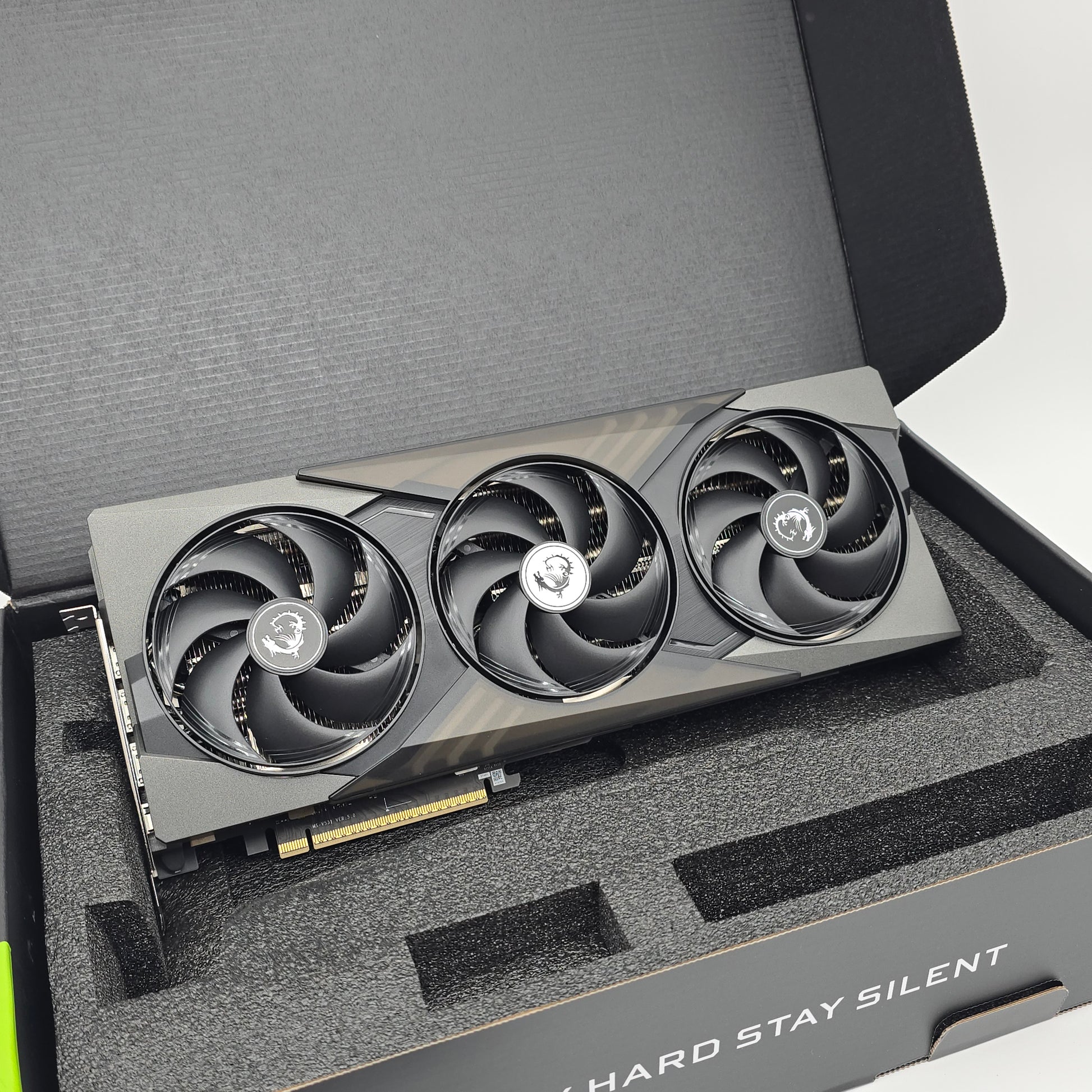 Gaming graphics card with three fans in a protective foam tray.
