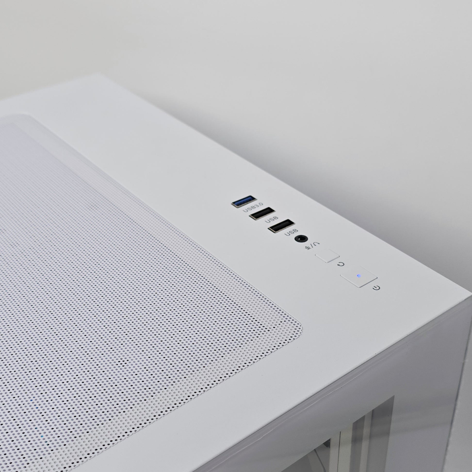 Close-up of a white electronic device with control buttons on a light gray background