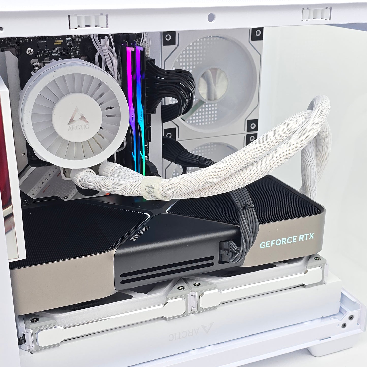 Open computer case with a GeForce RTX graphics card inside, showing internal components.