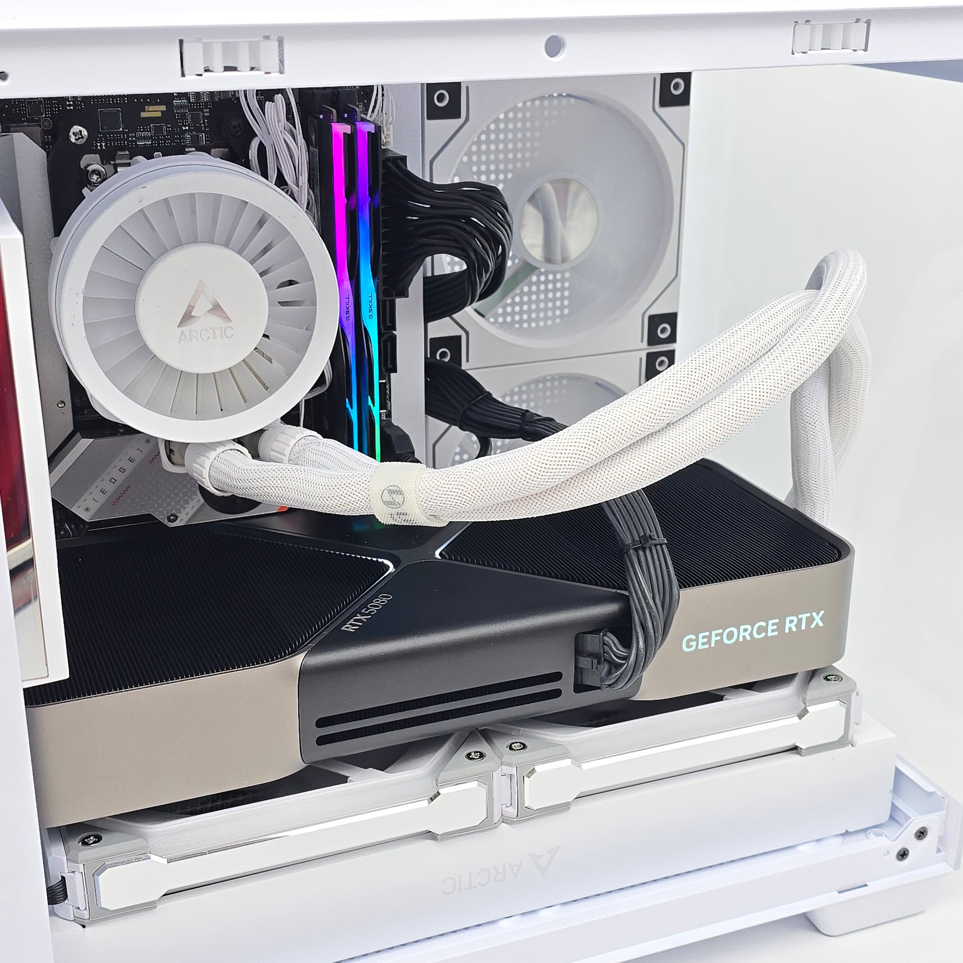 Open computer case with a GeForce RTX graphics card inside, showing internal components.