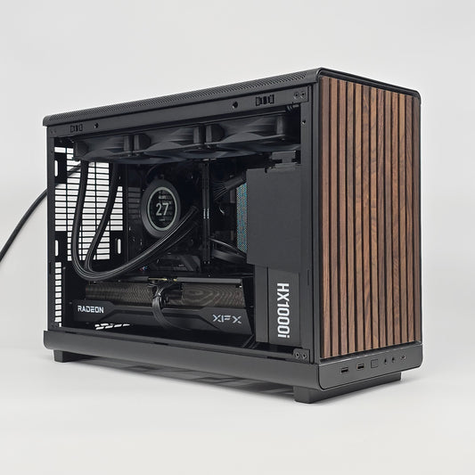 Computer case with wooden side panel on a white background, case is a lian li dan a3 wood, gpu is an xfx 9070 xt 16gb, has a kraken z73 nzxt liquid cooler, micro atx form factor
